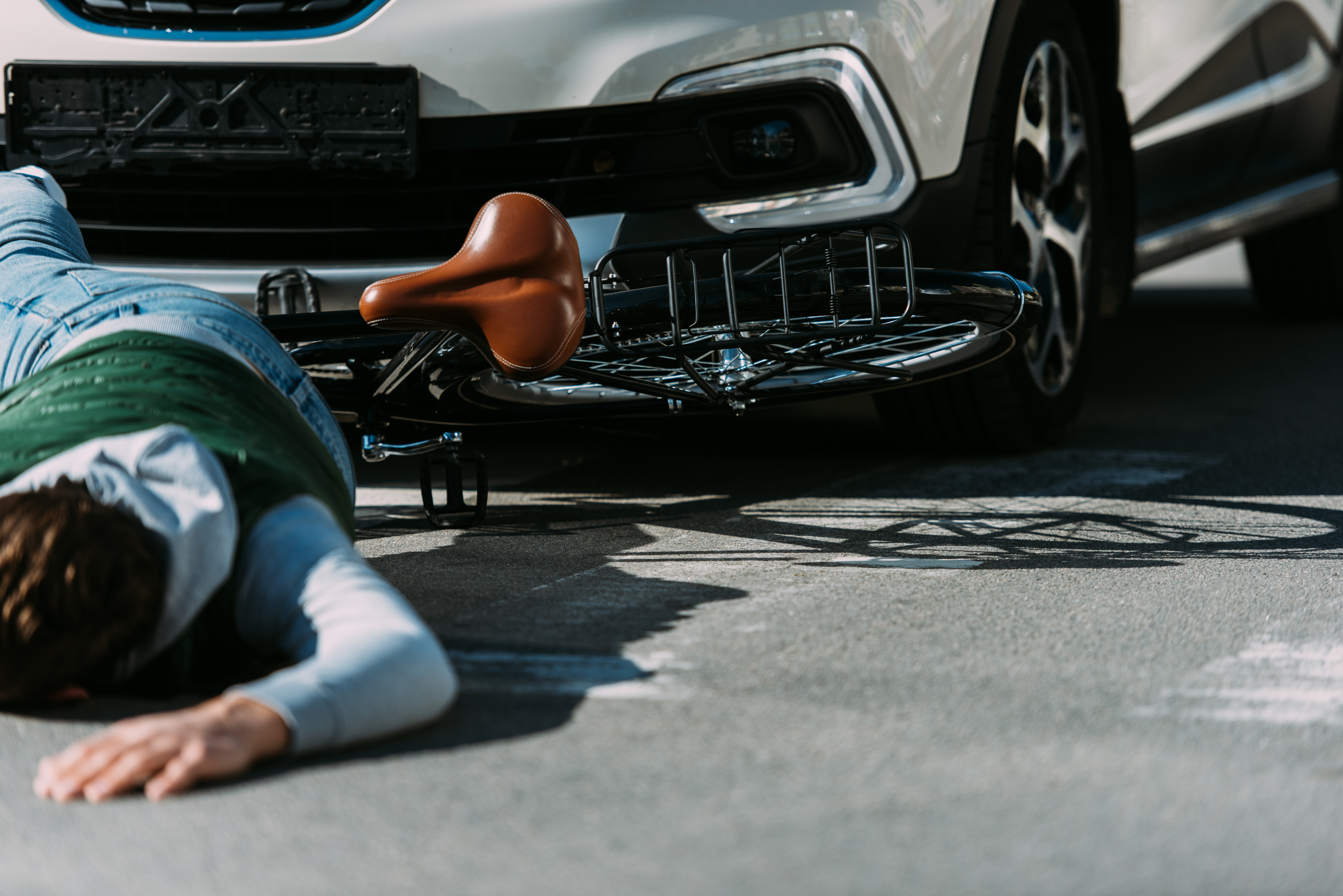 partial view of male bicycle rider hit by car on road car accident concept
