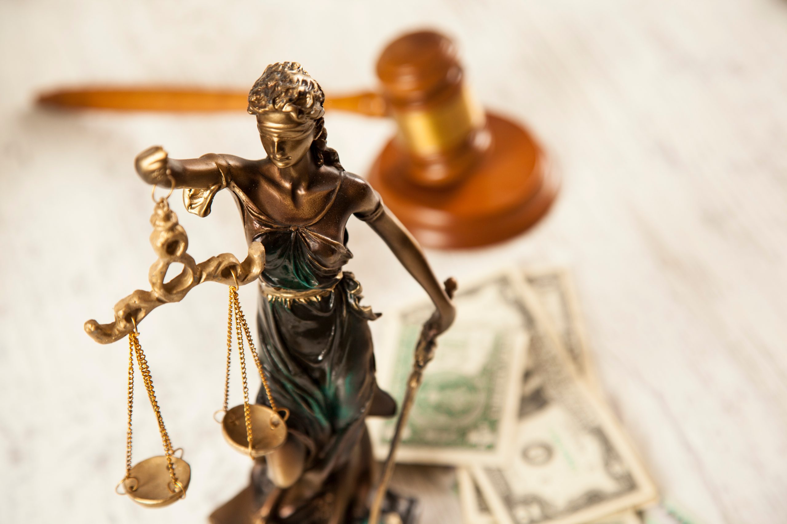 judge and justice lady and money on desk