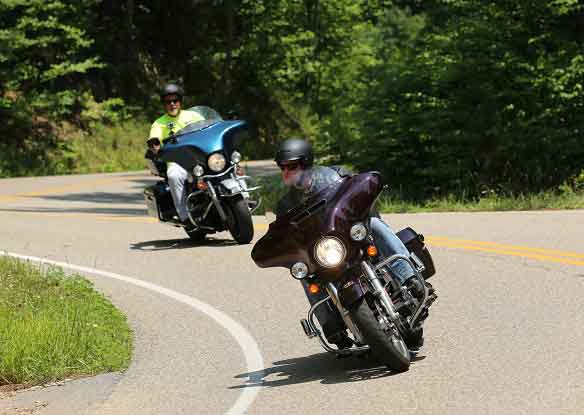 two men on motorcycles during the summer