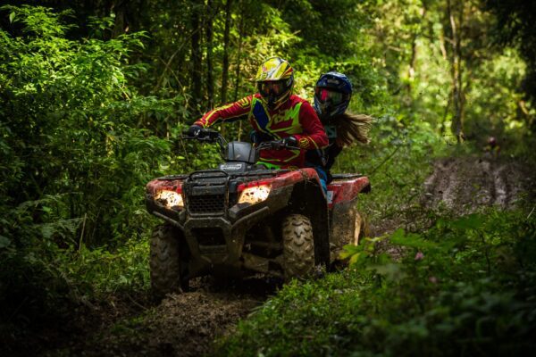 two people riding an atv
