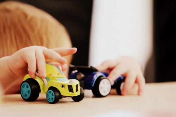 Toddlers playing with cars