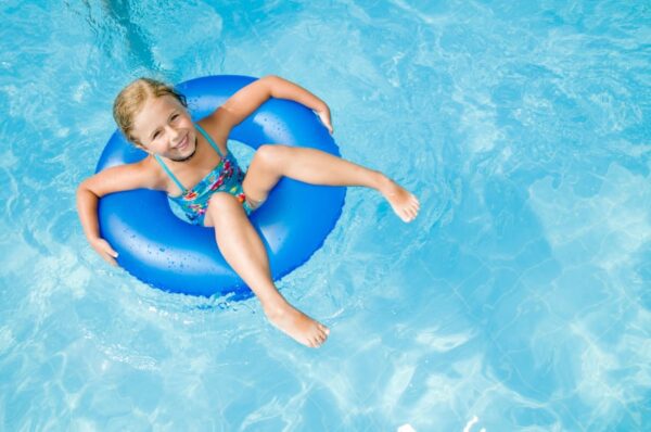 little girl in a float in a swimming pool